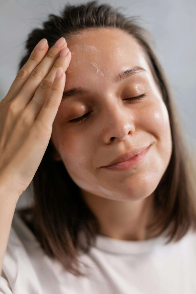 The Eye Wearhouse Olds facial treatments woman touching face