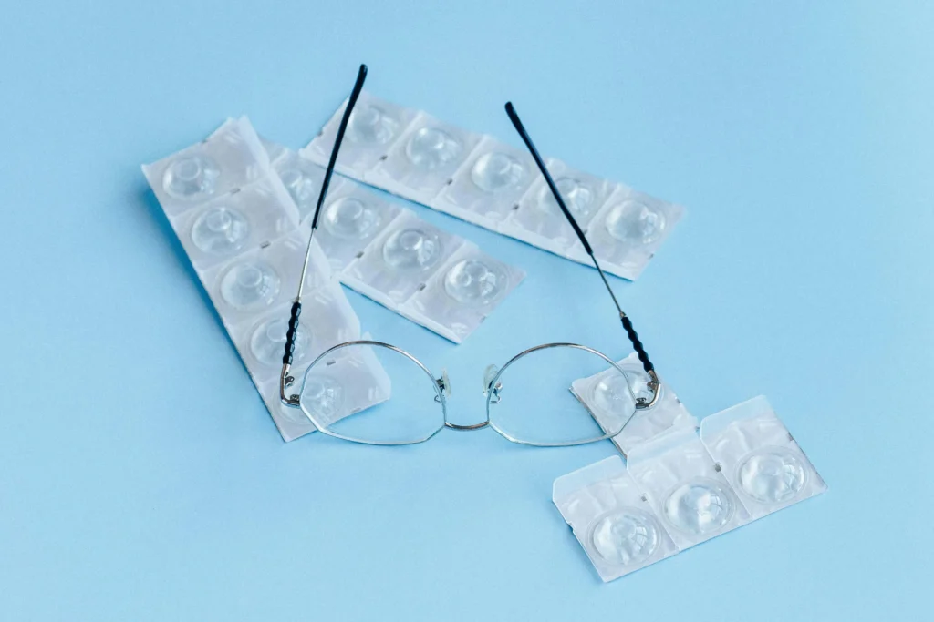Contact lenses on a blue background with glasses The Eye Wearhouse 